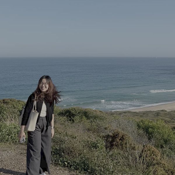student-walking-beach