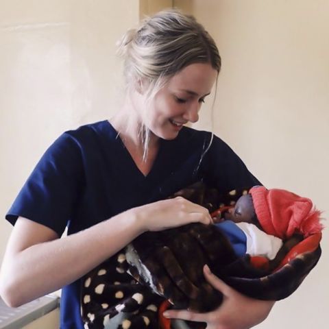 Kate Tolhurst holding a baby she helped deliver in Africa. Local nurse making big change in small communities