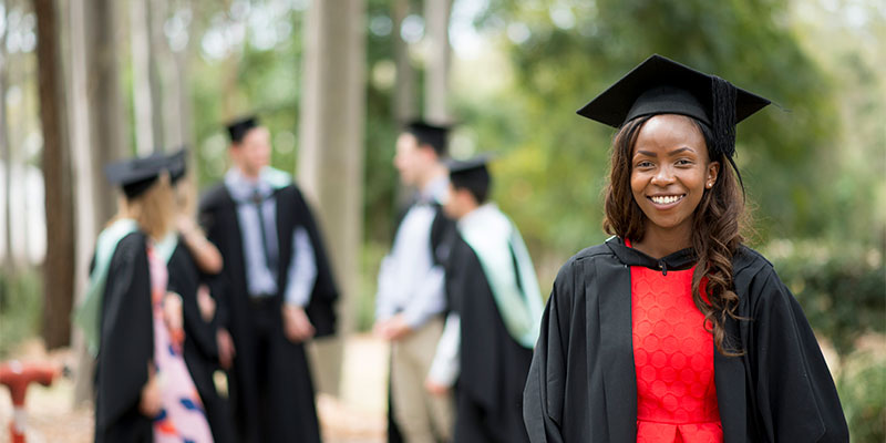A smiling student graduating