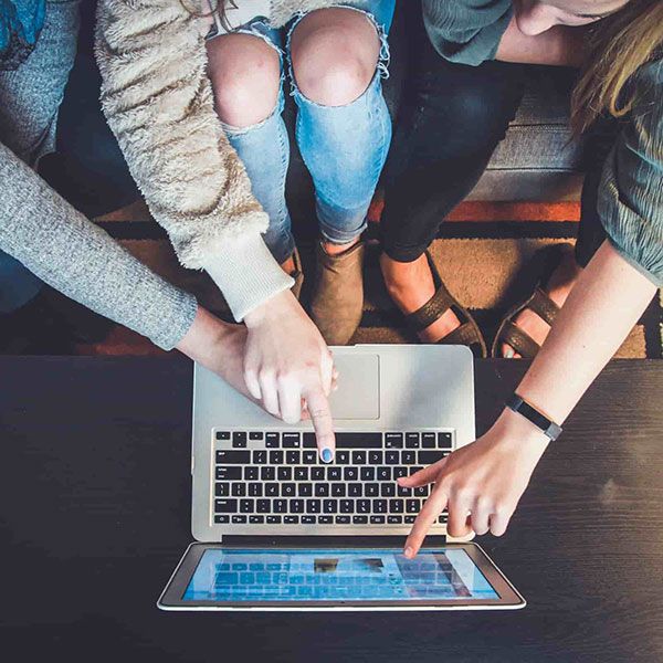 Students working at computer in a group