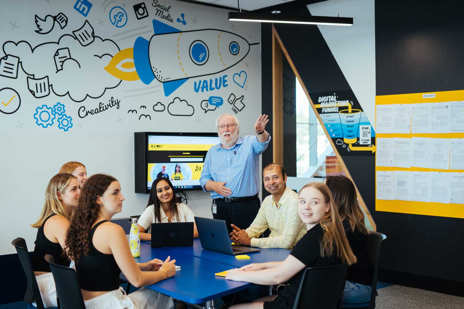 Lecturer teaching in a class of students.