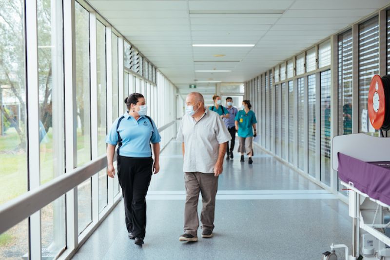 Victoria and Peter walking down the hall at Wyong Hospital