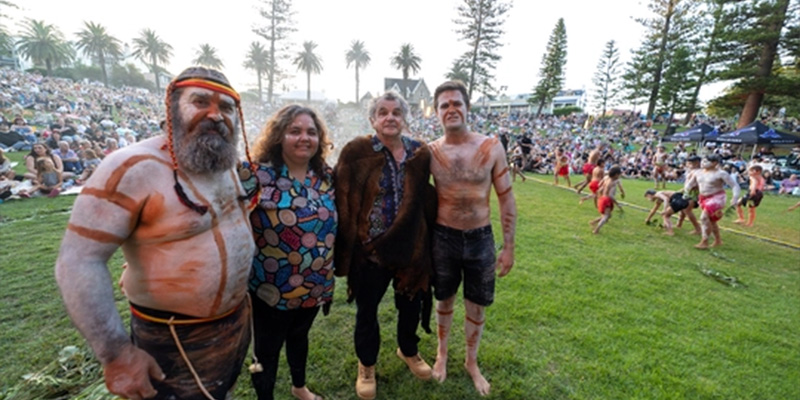 Four Aboriginal people at the Ngarrama event, the large crowd in the background 