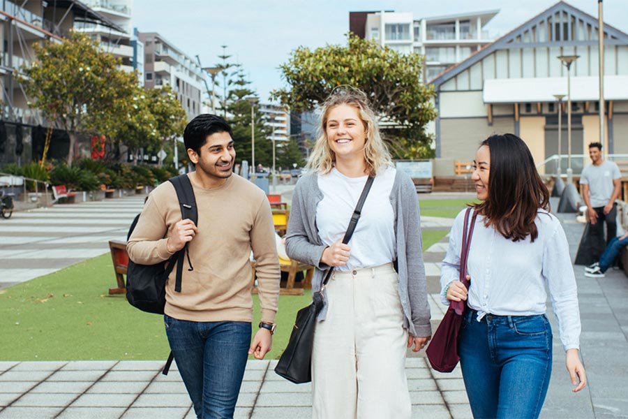 3 students walking in a city