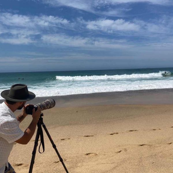 A person taking photos on a beach