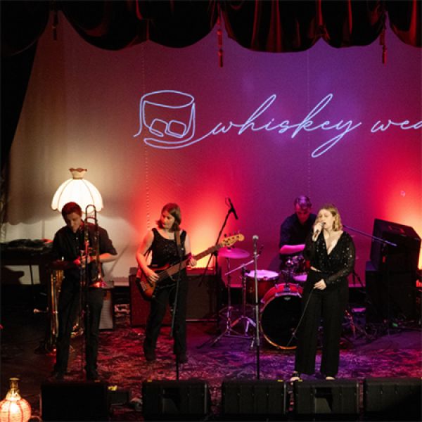 Students playing as a band on stage