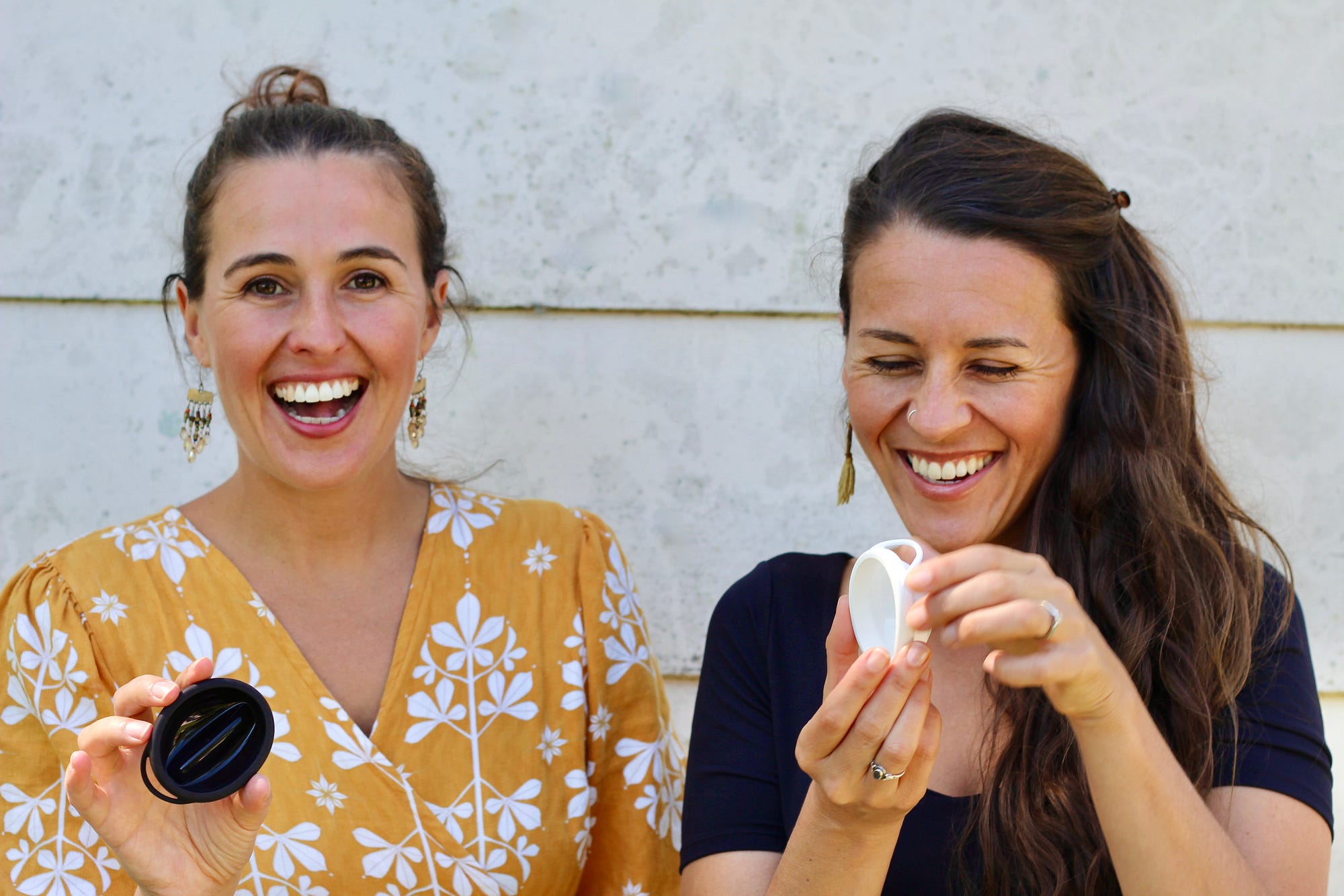 Mika and Zoe smiling and holding their startup invention