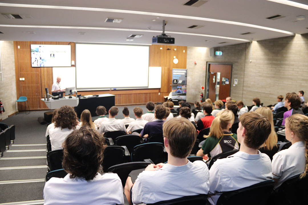 A staff member presents to all student attendees in a lecture theatre