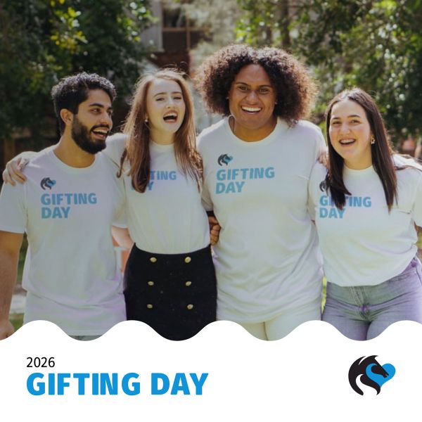 Five students smiling to camera wearing white Gifting Day t-shirts