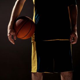 Basketball player with ball. Funding to help athletes rebound from injury