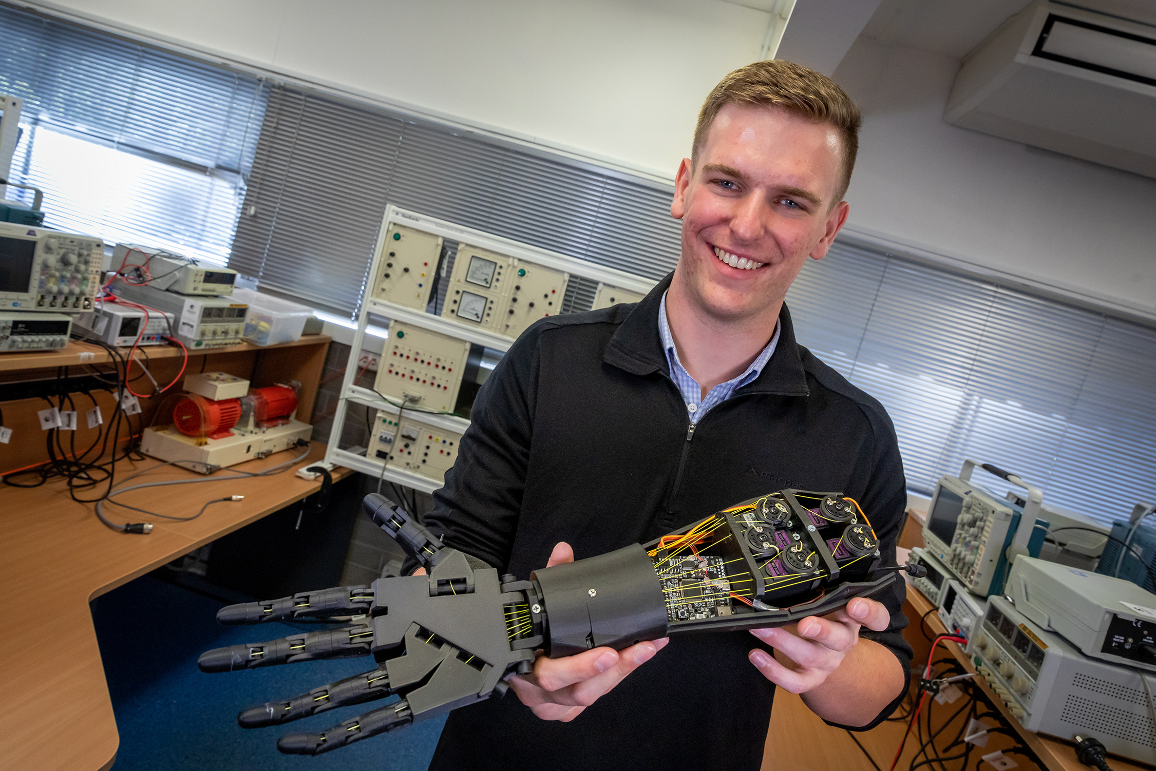 man holding robotic arm