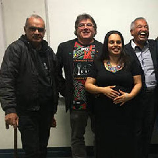 Three men and one woman smiling/laughing. Silence, violence and myths of social inclusion 