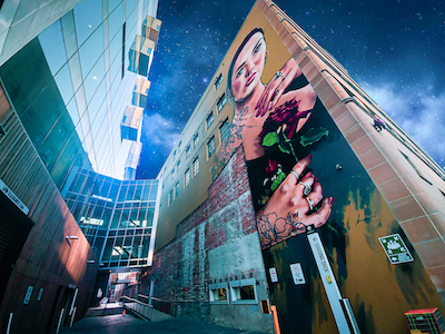 Photo of a mural depicting a woman holding a rose