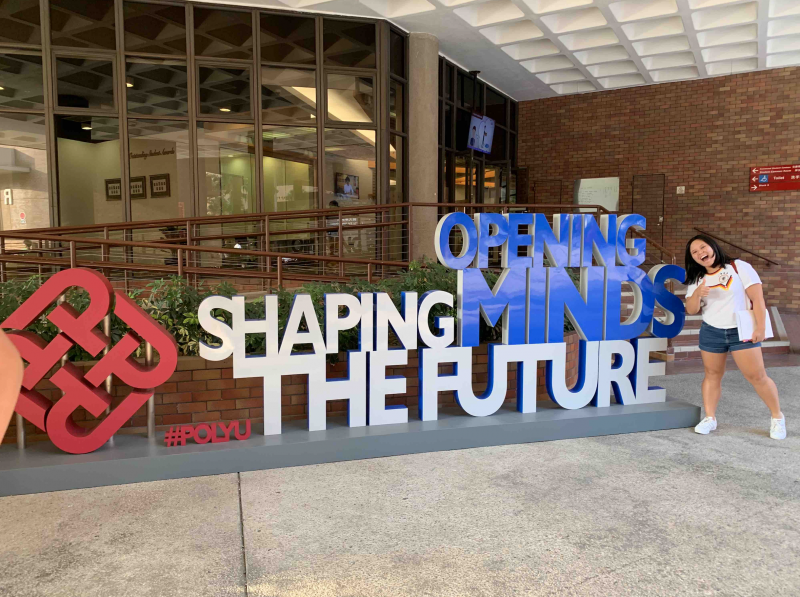 Josiebel infront of the Hong Kong Polytechnic University sign