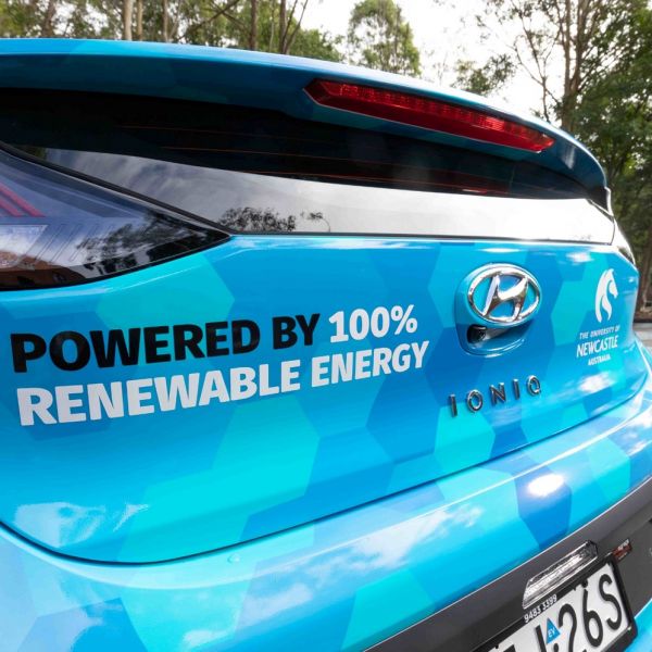 A picture of a car that says powered by 100% renewable energy. University of Newcastle in Top 100 Most Sustainable Universities in the World