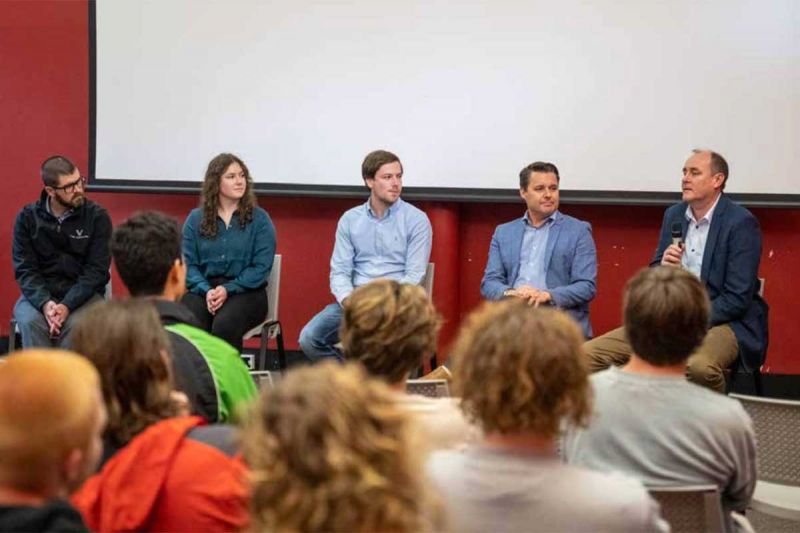 A panel speaking to students