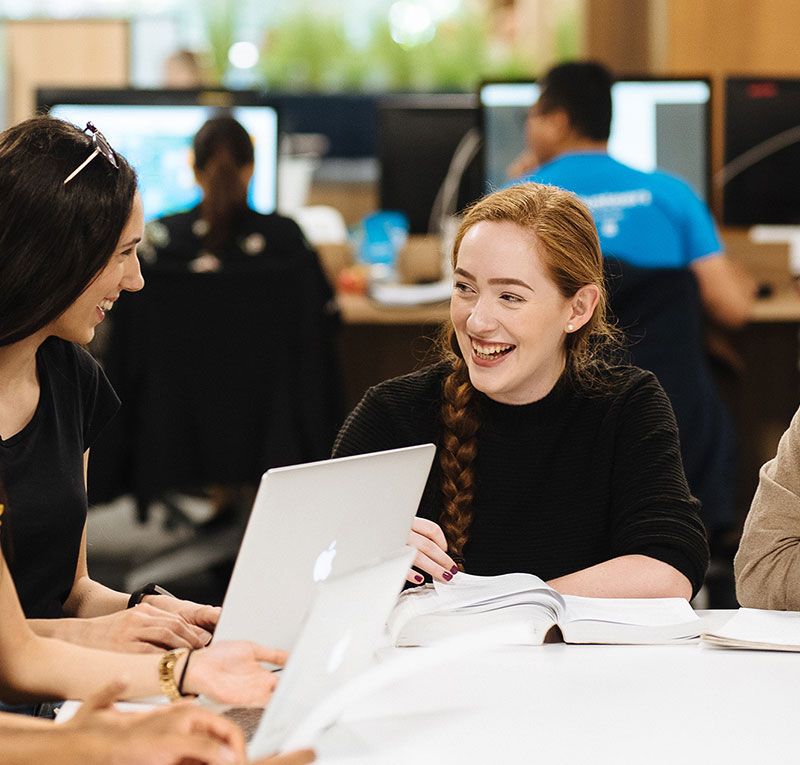 Two students interacting in the Library
