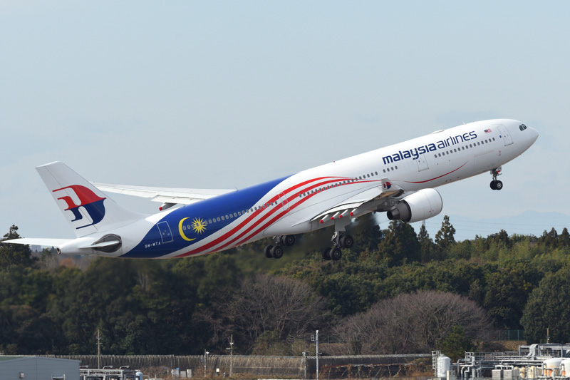 Malaysian airlines flight taking off on the runway.
