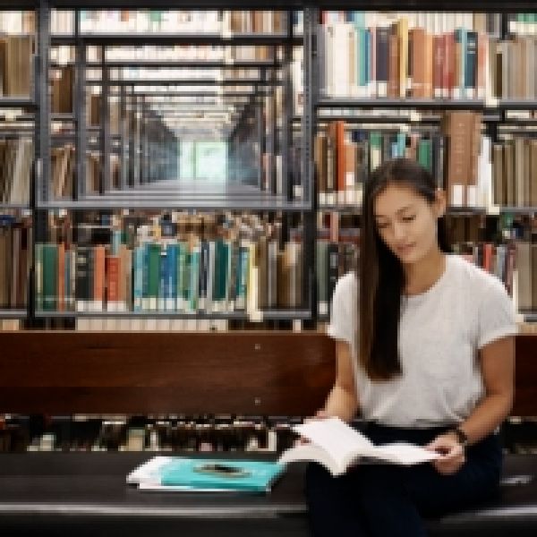 Student reading in a library