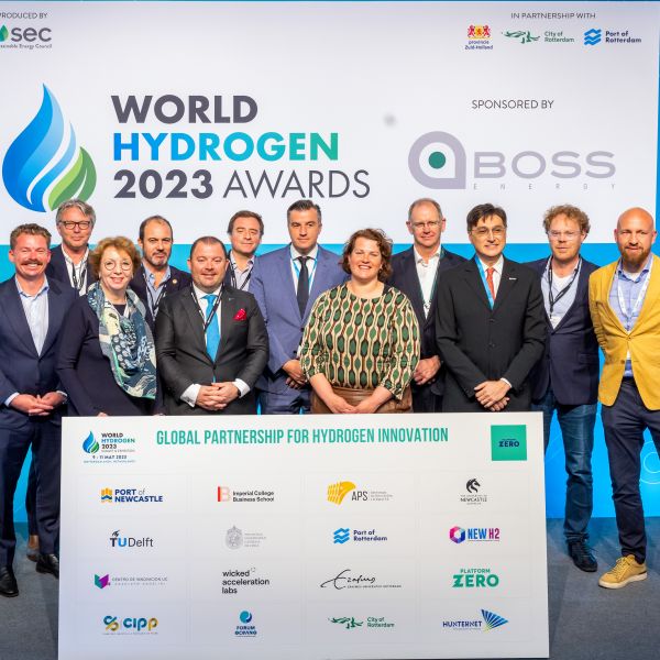 The group of representatives at the World Hydrogen Awards 2023 stand together behind a board that includes the logo for each partnership