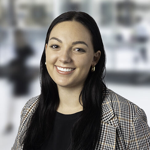 Talia in a checkered blazer smiling 