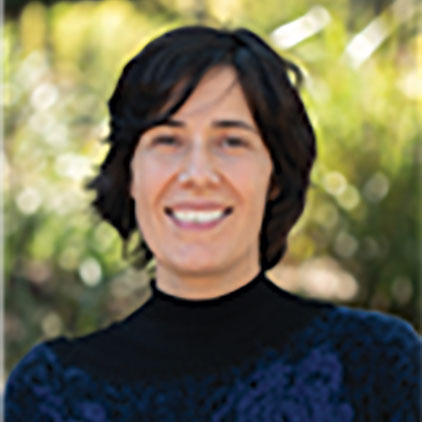 Dr Irene Perez Lopez A woman smiling at the camera with an unfocused outdoor background