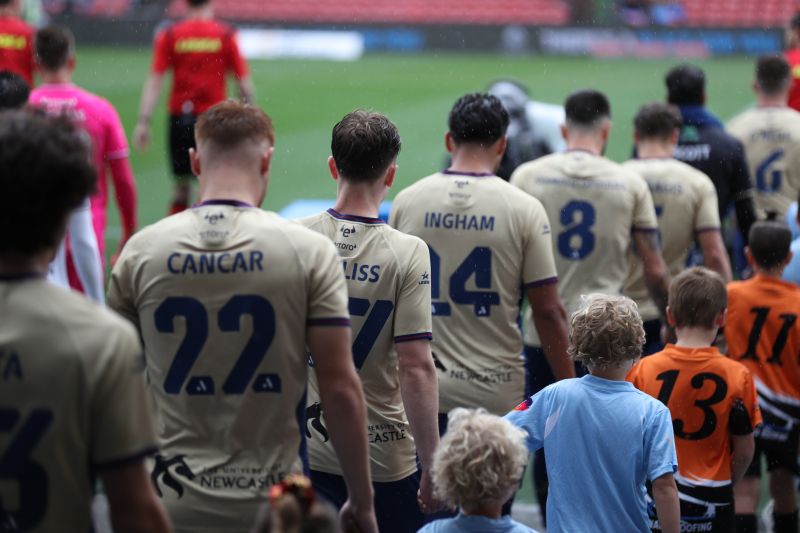 Jets Mens team walking onto field with young boys