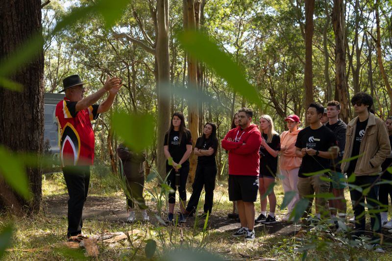2023 Scholars learning from Uncle Paul Gordon on Awabakal Country