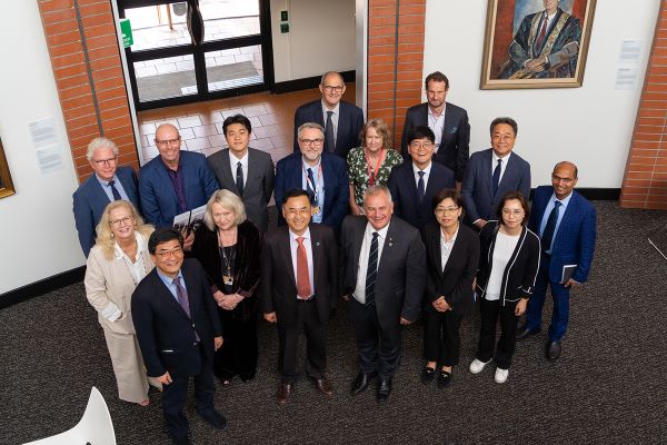 Members of University staff standing with Pusan National University staff