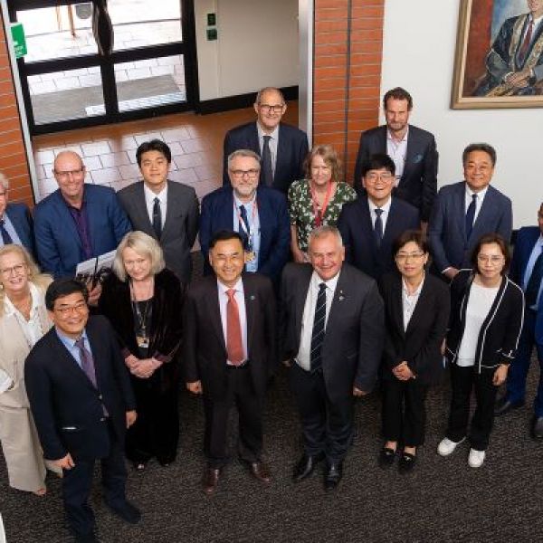Members of University staff standing with Pusan National University staff. Pusan National University President visits to discuss education and engineering