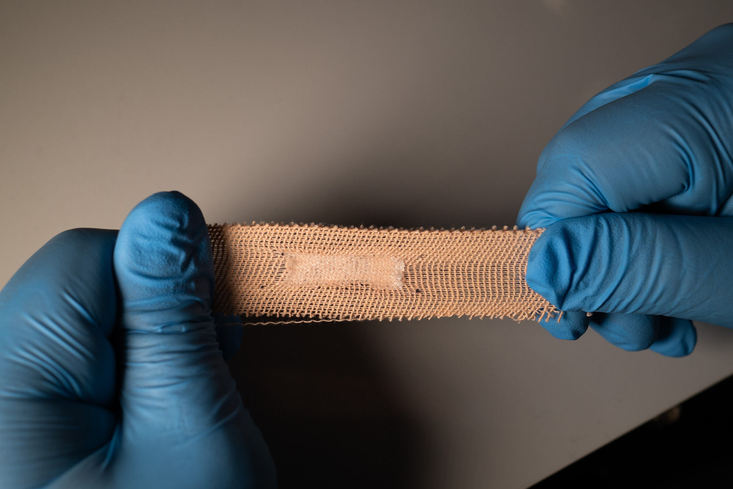 close up of a bandaid being stretched