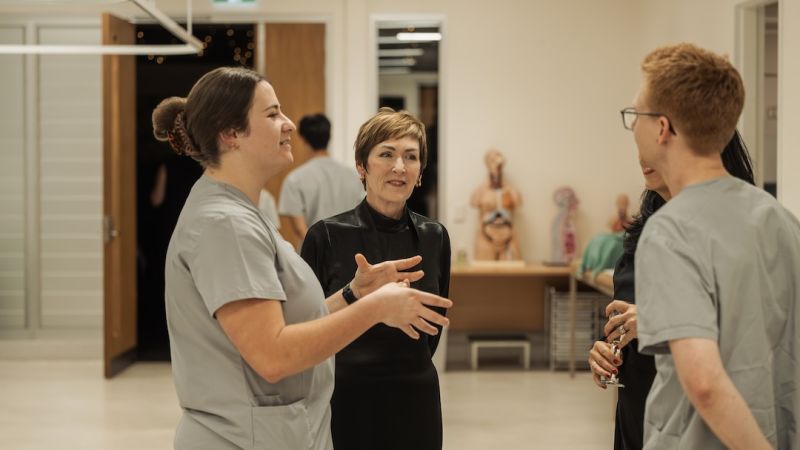 Group of medicine students talking to event guests