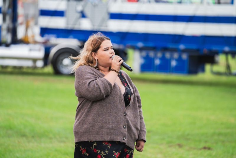 Student Maddie Lilley singing the National Anthem