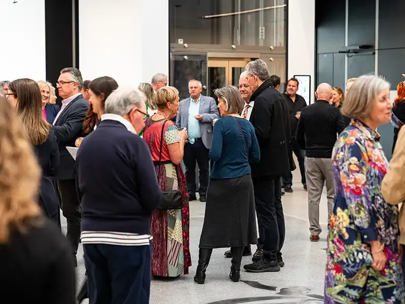A crowd mingles at a Newcastle Art Gallery event.