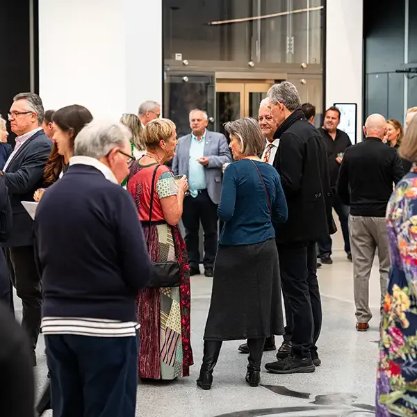 A crowd mingles at a Newcastle Art Gallery event.