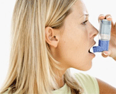 Female using asthma medication
