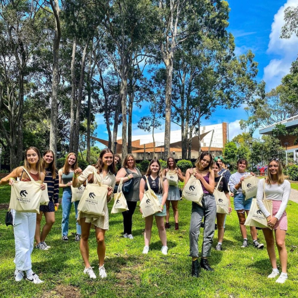 Students holding Orientation merchandise