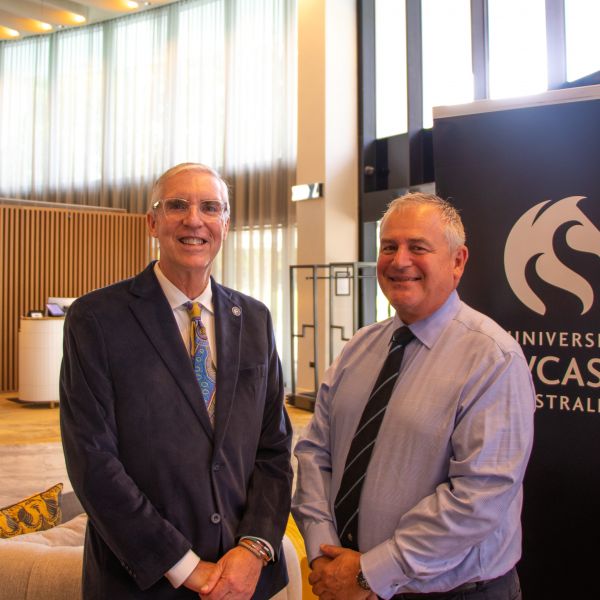 Professor John Fischetti and Professor Alex Zelinsky stand together smiling in the Crystalbrook Kingsley Hotel lobby
