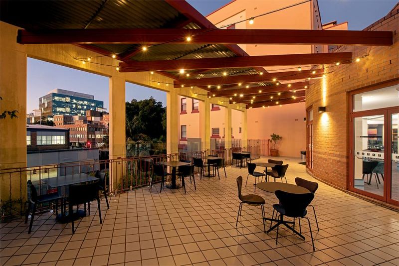 View of outside deck, fairy lights and seating.