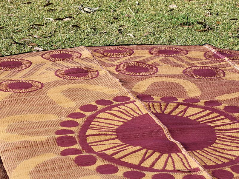 A close-up shot of a Yarning Mat, showing off the vibrant colours and patterns.