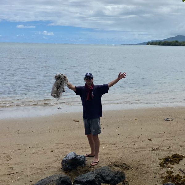 Nick holding debris from a beach in Samoa