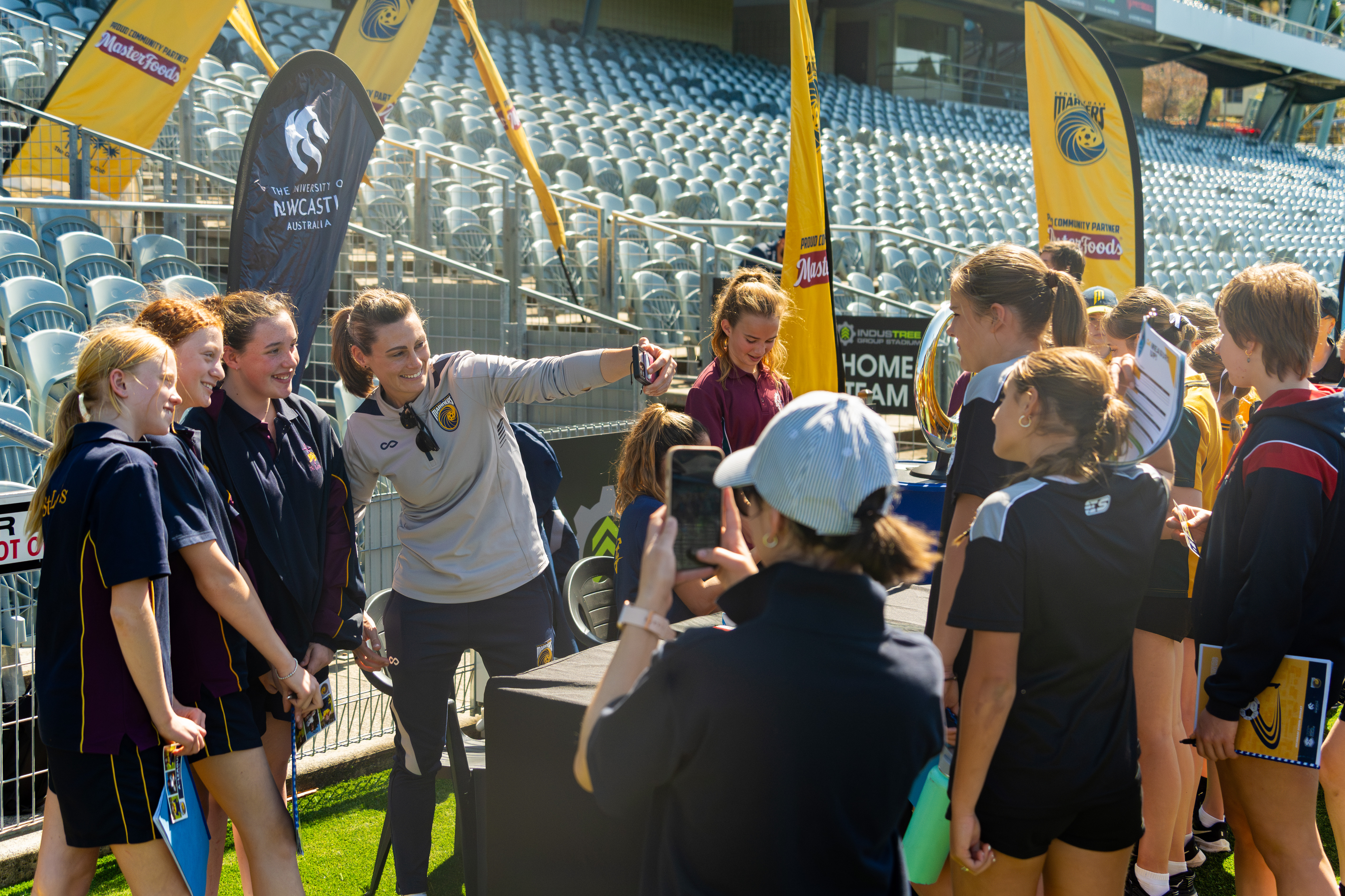 Mariners A-League Women's Head Coach Emily Husband takes a selfie with students