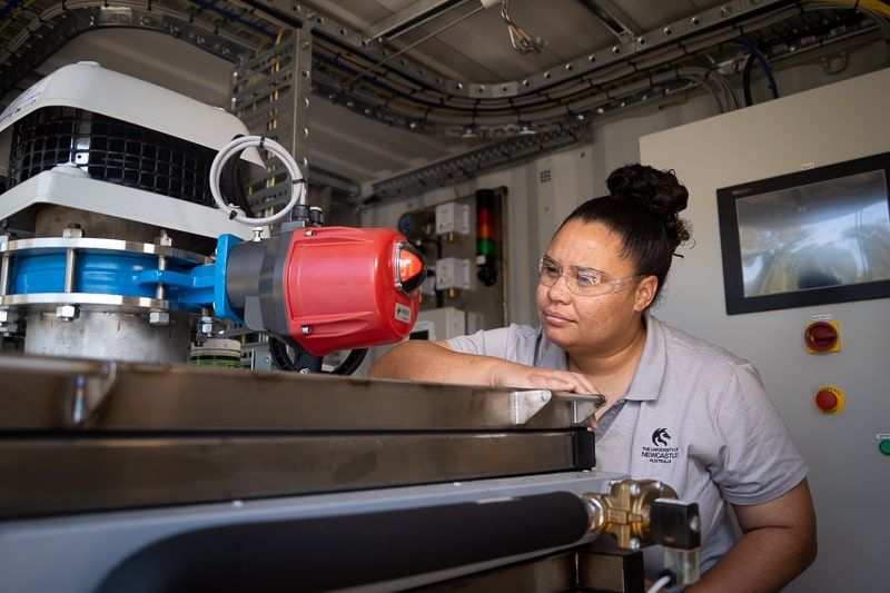 researcher, Priscilla, pictured wearing safety goggles while inspecting the Hydro Harvester