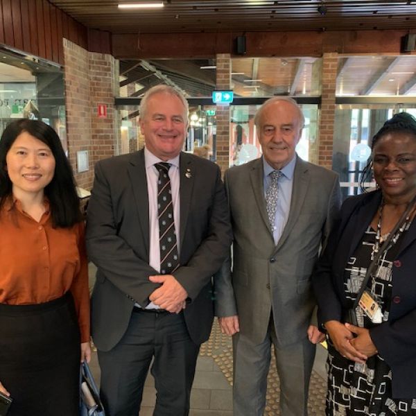 two senior members of Australian African Universities Network and two Senior Administrators of the University of Newcastle standing together smiling for a photo