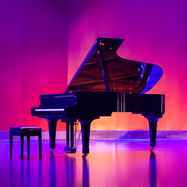 Grand Piano on a stage with pink and purple lighting