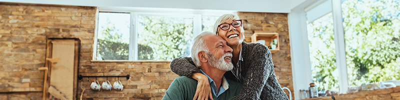 An elderly couple cuddling