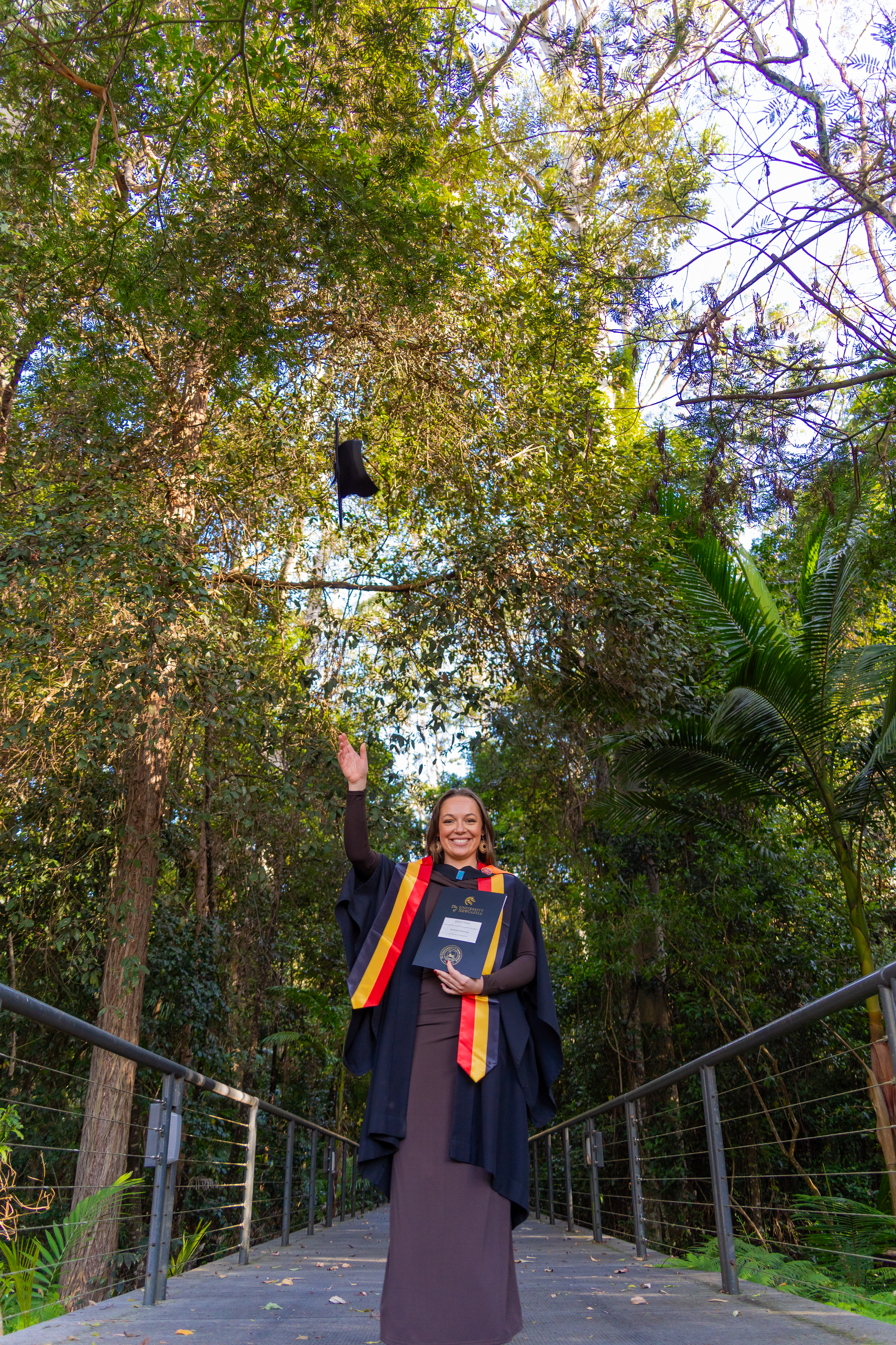 Graduate throws cap into air