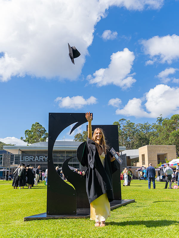 Piper throws her graduation cap into the sky