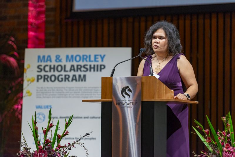 A woman speaking at a lecturn