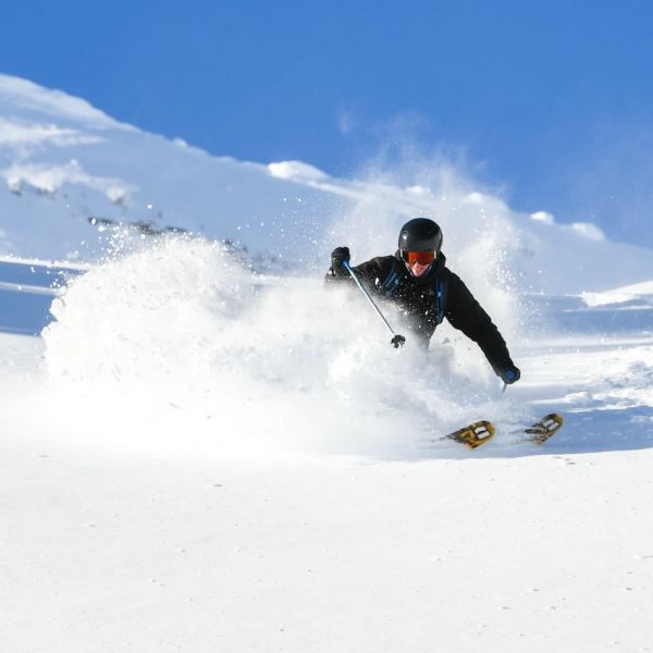 Luke Ellis Luke Ellis skiing down a mountain in a snowy location